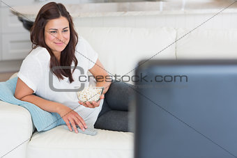 Woman enjoying tv with popcorn