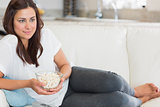 Woman eating popcorn while relaxing