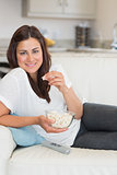 Brunette eating popcorn and relaxing