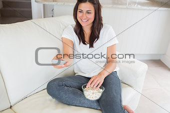 Woman smiling and changing channel