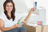 Woman happily choosing paint colours