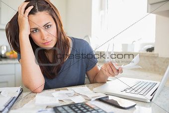 Young woman looking worried over finances