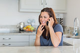 Brunette woman smiling and calling