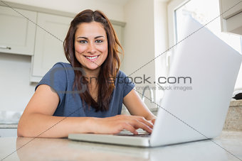 Woman smiling and using laptop