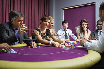 Woman looking up from poker game