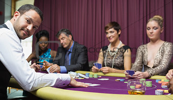 Dealer smiling at poker game