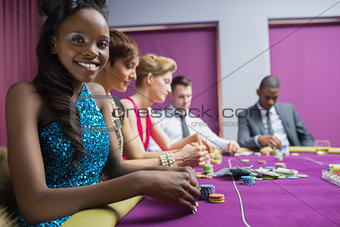 Smiling woman looking up from poker