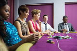 People sitting at poker table