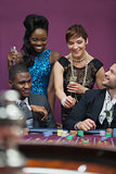 Women with champagne standing at roulette table