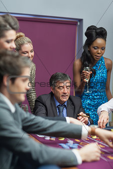 Women watching men placing bets