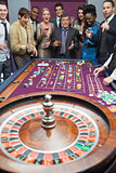 People standing at the roulette table