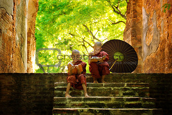 Buddhist monk reading outdoors