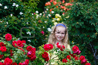 Portrait girl and rose bushes