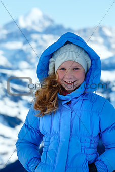 Happy girl portrait on winter  mountain background.