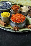 collection of various spices (paprika, turmeric, pepper, aniseed, cinnamon, saffron)