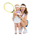 Portrait of happy mother and baby holding tennis racket