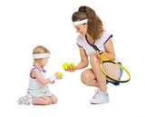 Mother and baby in tennis clothes playing