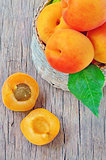 fruits apricot in basket on wooden background