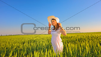 beautiful girl with hat in the field