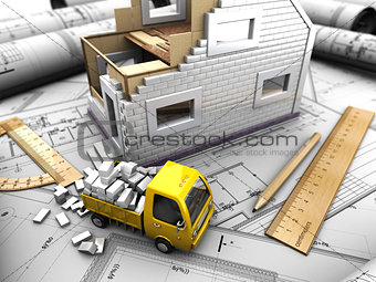 yellow truck and model of house