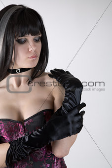 Goth girl in purple corset and black gloves 