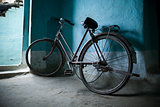 Old bicycle leaning against a wall