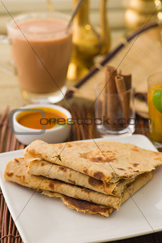 chapati Paratha Fold with traditional indian items background