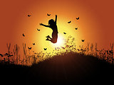 Girl jumping against sunset sky