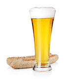 Light beer in glass and two grilled sausages
