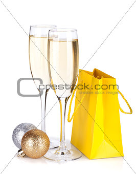 Champagne glasses, christmas baubles and gift bag