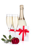 Two champagne glasses, letter and rose