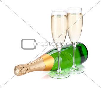 Lying champagne bottle and two glasses