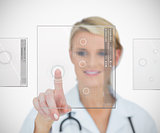 Doctor standing smiling while pressing on interface