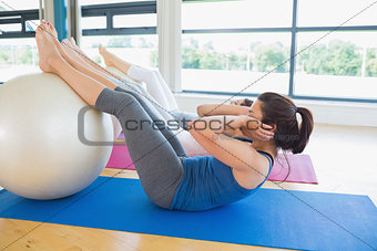 Women using exercise ball for sit ups