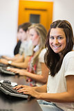 Student sitting at the computer smiling