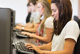 Woman looking at the keyboard in computer class in college
