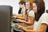 Students sitting at the computer smiling