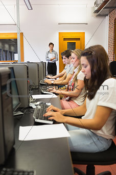 Students sitting at the computer concentrating
