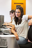 Student sitting at the computer while smiling
