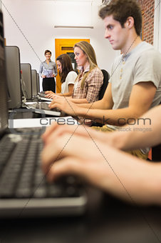 Students sitting at the computer working