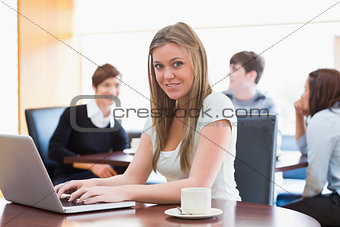 Woman sitting at the coffee shop at table using laptop