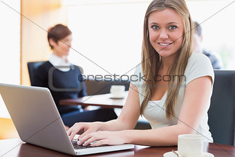 Student sitting at the coffee shop with laptop