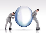 Businessmen pushing a bubble