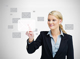 Businesswoman touching email symbol