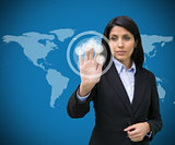 Businesswoman touching holographic screen against blue background