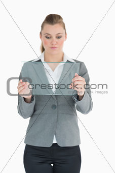 Businesswoman studying glass pane