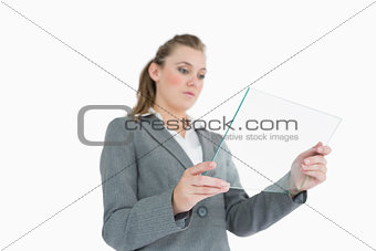 Blonde businesswoman viewing glass pane