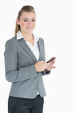 Businesswoman texting while smiling