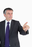 Serious businessman pointing on something