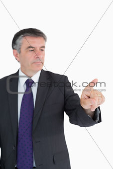 Serious businessman pointing on something
